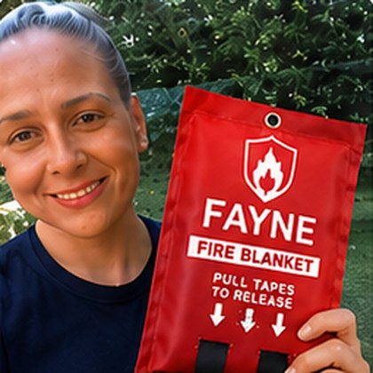 Fayne customer holding their fire blanket at home