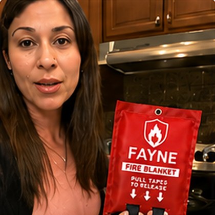 Fayne customer holding their fire blanket at home